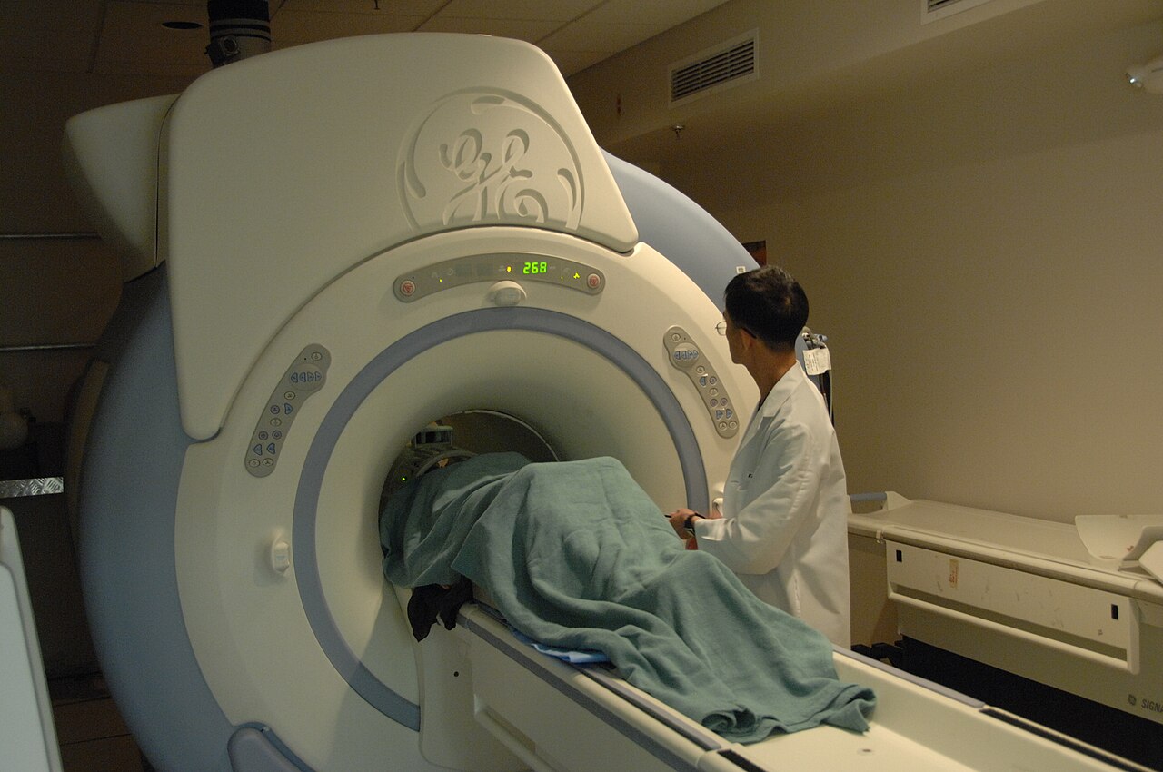 A medical professional assisting a patient during diagnostic imaging